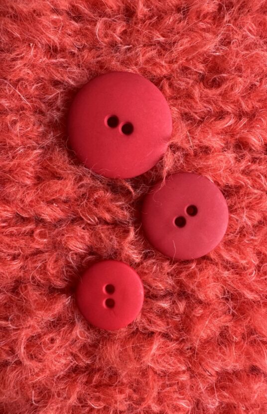 Red matte plastic button