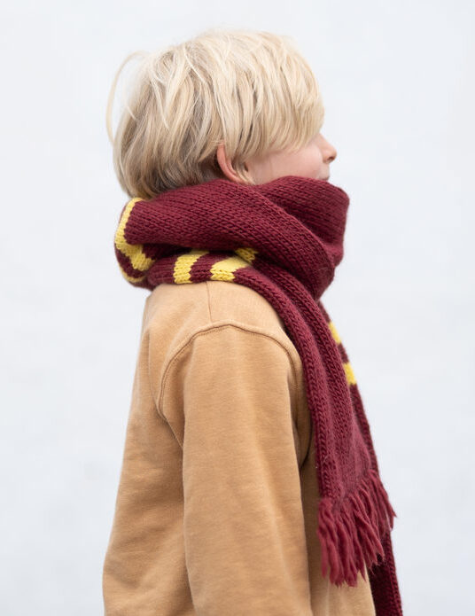 Hogwarts House Scarf Knitting Pattern**Materials:***   Worsted weight yarn in the colors of your chosen Hogwarts house (e.g., for Gryffindor: red and gold; for Slytherin: green and silver; for Ravenclaw: blue and bronze; for Hufflepuff: yellow and black). You will need approximately 200-300 yards of each color, depending on your desired scarf length.*   Knitting needles: Size US 7 (4.5 mm) or size needed to obtain gauge.*   Scissors*   Tapestry needle for weaving in ends.**Gauge:**4 stitches and 6 rows = 1 inch in stockinette stitch. (This is approximate and can be adjusted slightly depending on your preference for scarf width.)**Instructions:**This pattern uses simple and repetitive stripes. You can adapt this to any length you desire.1.  **Cast on:** Cast on 30 stitches using your primary house color (Color A).2.  **Row 1 (Right Side):** Knit all stitches.3.  **Row 2 (Wrong Side):** Knit all stitches. (This is the Garter Stitch section. You will do this for the first 7 rows of each stripe color to create a slightly thicker, more defined edge.)4.  **Begin Striping (Color A):**    *   Work in stockinette stitch (knit on right side rows, purl on wrong side rows) for 1 inch (approximately 6 rows).5.  **Switch to Color B:**    *   Change to your secondary house color (Color B).    *   Work in stockinette stitch for 1 inch (approximately 6 rows).6.  **Continue Alternating Colors:**    *   Continue alternating between Color A and Color B, working each color for 1 inch (approximately 6 rows) before switching. This will create your house stripes.7.  **Repeat:** Continue alternating colors until the scarf reaches your desired length. A typical scarf length is between 5 and 6 feet.8.  **Final Stripe:** For the last section of the scarf, you can do one of the following:    *   **Continue alternating:** If you want the end of the scarf to have multiple stripes.    *   **Finish with Color A:** Work the last 1 inch (approximately 6 rows) in Color A for a consistent finished edge.9.  **Garter Stitch Edging (Optional but Recommended):**    *   After completing your last colored stripe, switch back to Color A (or the color you want for your final edge).    *   Work in Garter stitch (knit every row) for approximately 1 inch (about 7 rows). This will create a neat, finished edge to match the beginning.10. **Bind off:** Bind off all stitches loosely.11. **Weave in ends:** Using your tapestry needle, carefully weave in all yarn tails to secure them and give your scarf a clean finish.**Tips and Variations:***   **Scarf Width:** If you want a wider scarf, cast on more stitches. Remember to adjust your gauge swatch to ensure you're getting the fabric you want.*   **Strap Thickness:** You can make your stripes wider or thinner by working more or fewer rows of each color. For example, instead of 1 inch, work each color for 1.5 inches.*   **Fringe:** For a more traditional scarf look, you can add fringe to the ends. Cut strands of yarn, fold them in half, and loop them through the cast-on/bind-off stitches.*   **Pom-Pom:** A fun addition could be a small pom-pom in your primary house color.*   **Color Combinations:**    *   **Gryffindor:** Red and Gold    *   **Slytherin:** Green and Silver    *   **Ravenclaw:** Blue and Bronze/Yellow    *   **Hufflepuff:** Yellow and BlackEnjoy knitting your Hogwarts House scarf!