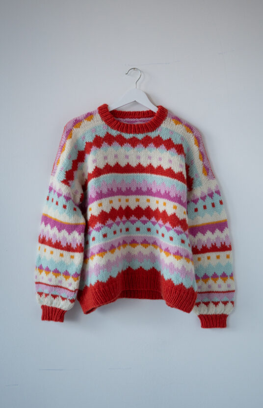 Knitted sweater with colors and pattern. Inspiration for hiking sweater women Lofoten hiking knit colorful