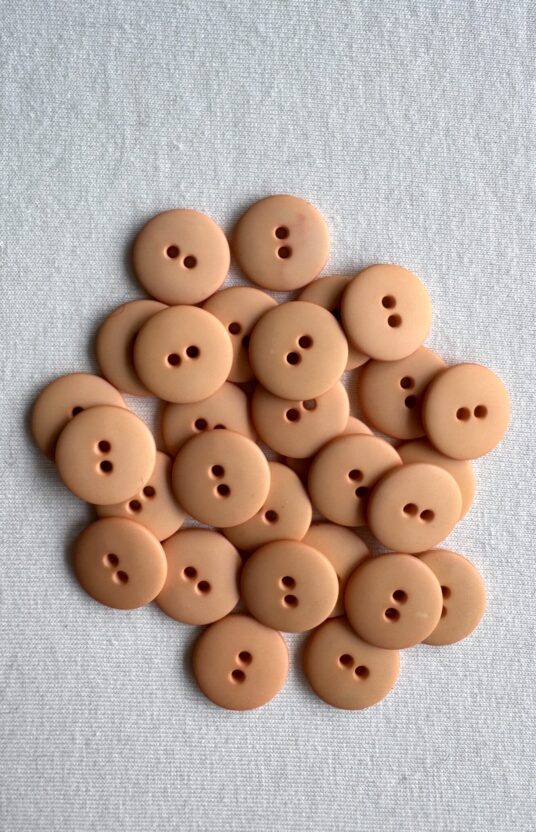 Peach matte plastic button