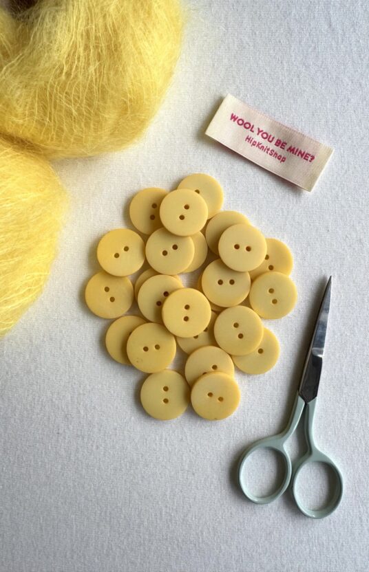 Light yellow plastic button
