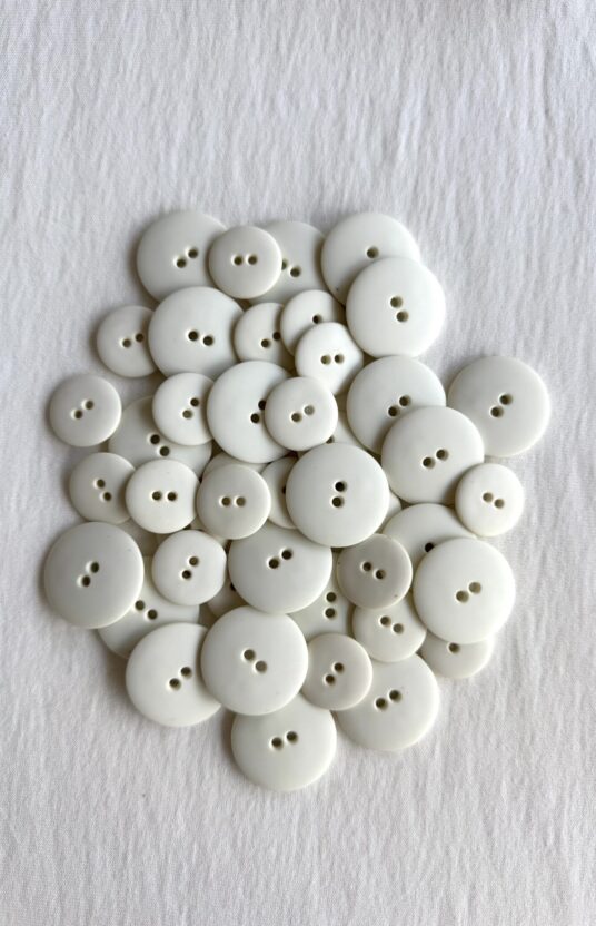 Natural white matte plastic button