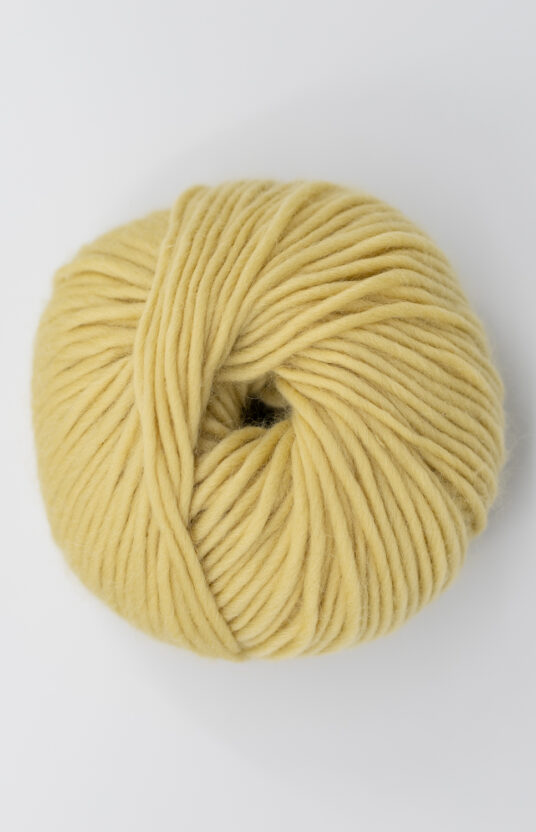 Dusty yellow yarn. Yarn for knitting with thick needles